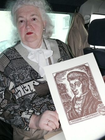 Theodoro Grotthuso fondo valdybos narė Marija Čiurlienė su dailininkės Albinos Makūnaitės sukurtuoju Teodoro Grothuso portretu (lino raižinys)